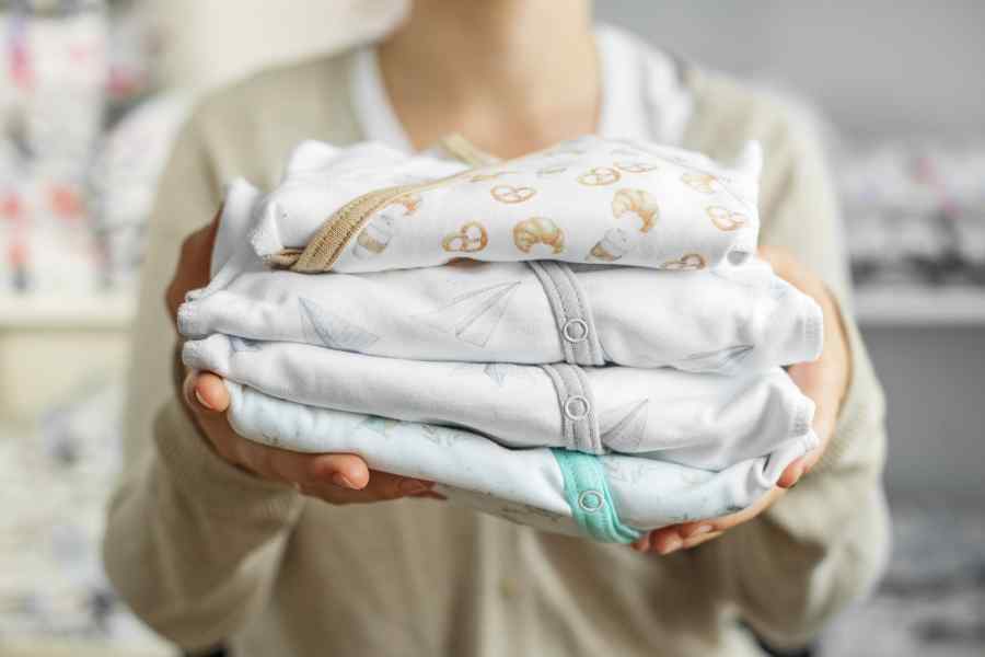 baby clothes in female hands set of beautiful bab 2022 09 23 21 15 24 utc 1