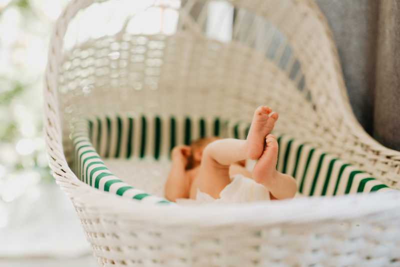baby feet sticking out of a vintage bassinet 2022 03 06 15 17 38 utc 1