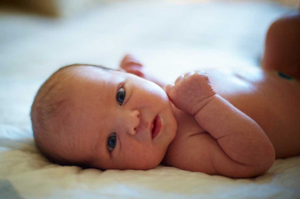 cute 3 days newborn baby lying in bed at home 2022 09 27 00 14 15 utc 1 1