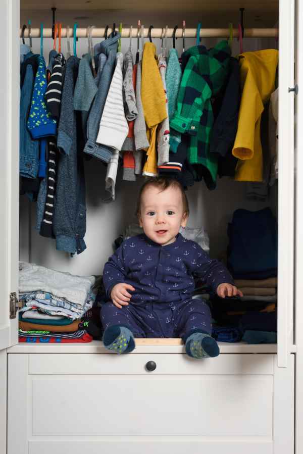 smiling kid hiden in clothing closet 2022 02 02 04 50 41 utc 1