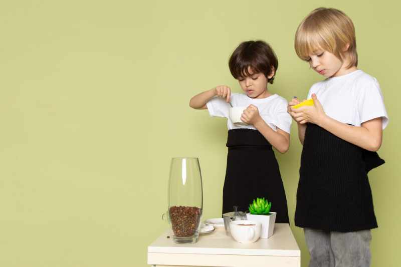 front view two boys white t shirts eating stone colored desk 179666 1072 1