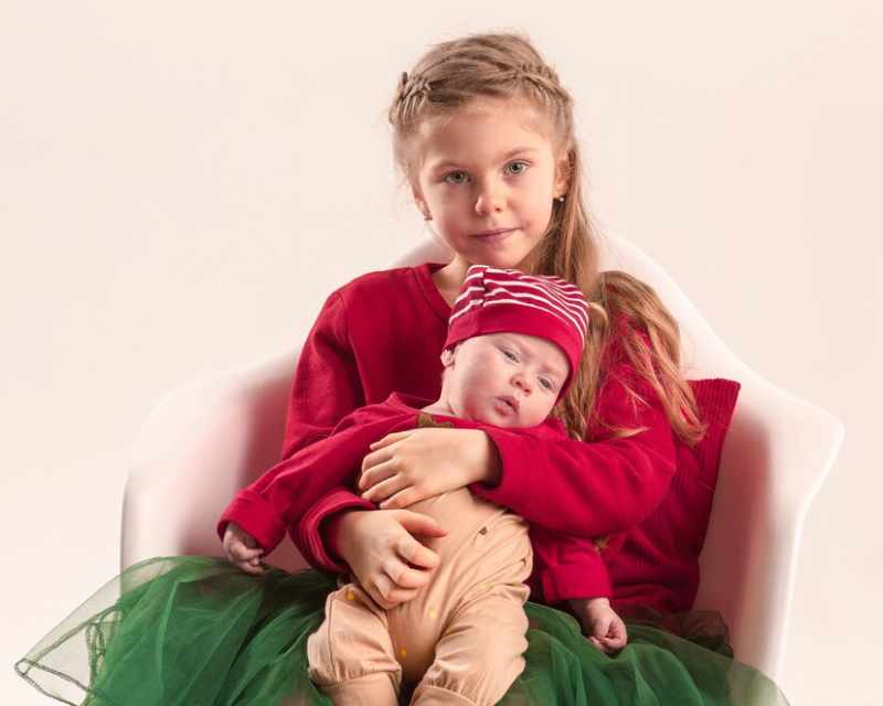happy little teen gir holding his newborn baby little sister studio 155003 23743 1
